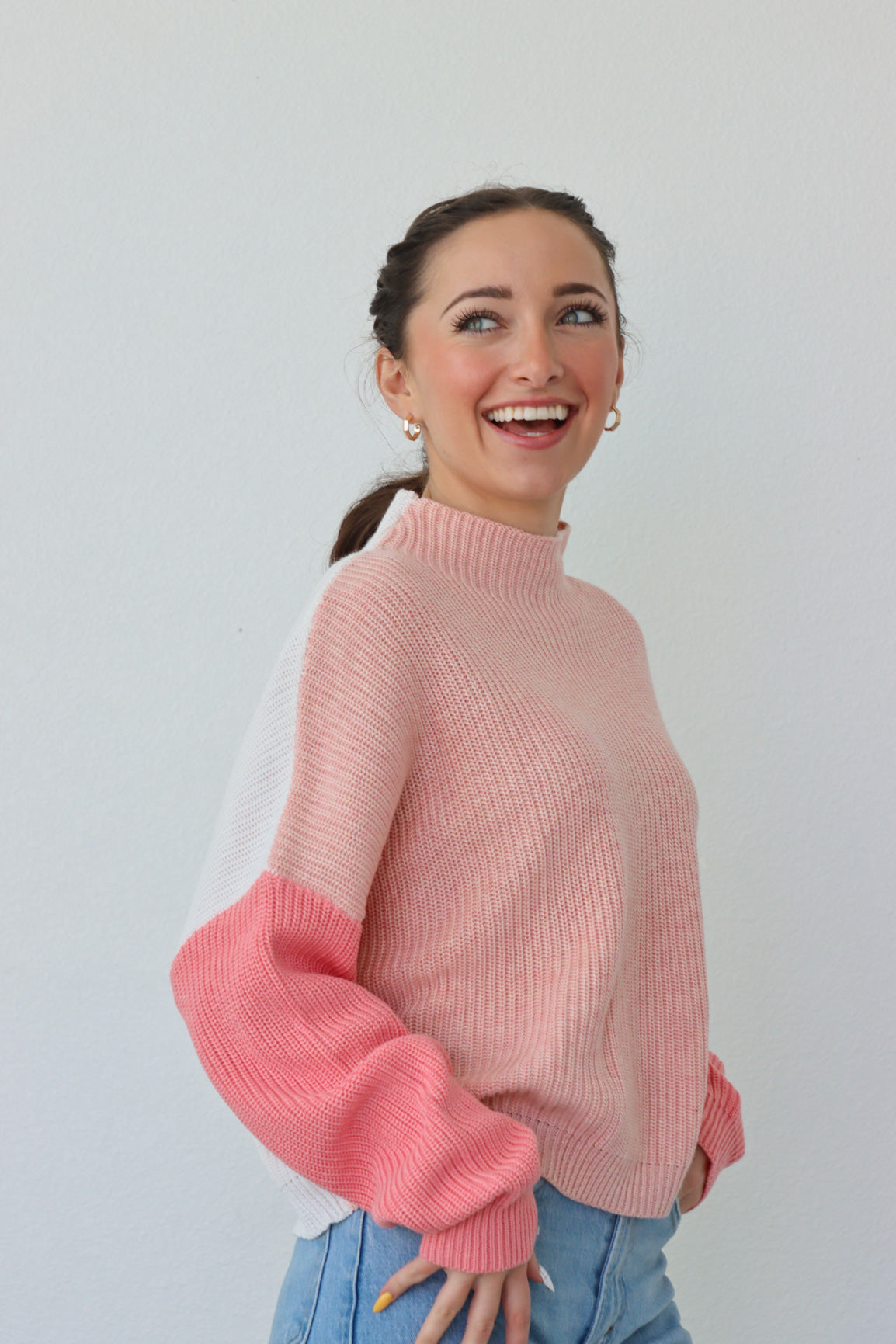 girl wearing pink & white colorblocked sweater