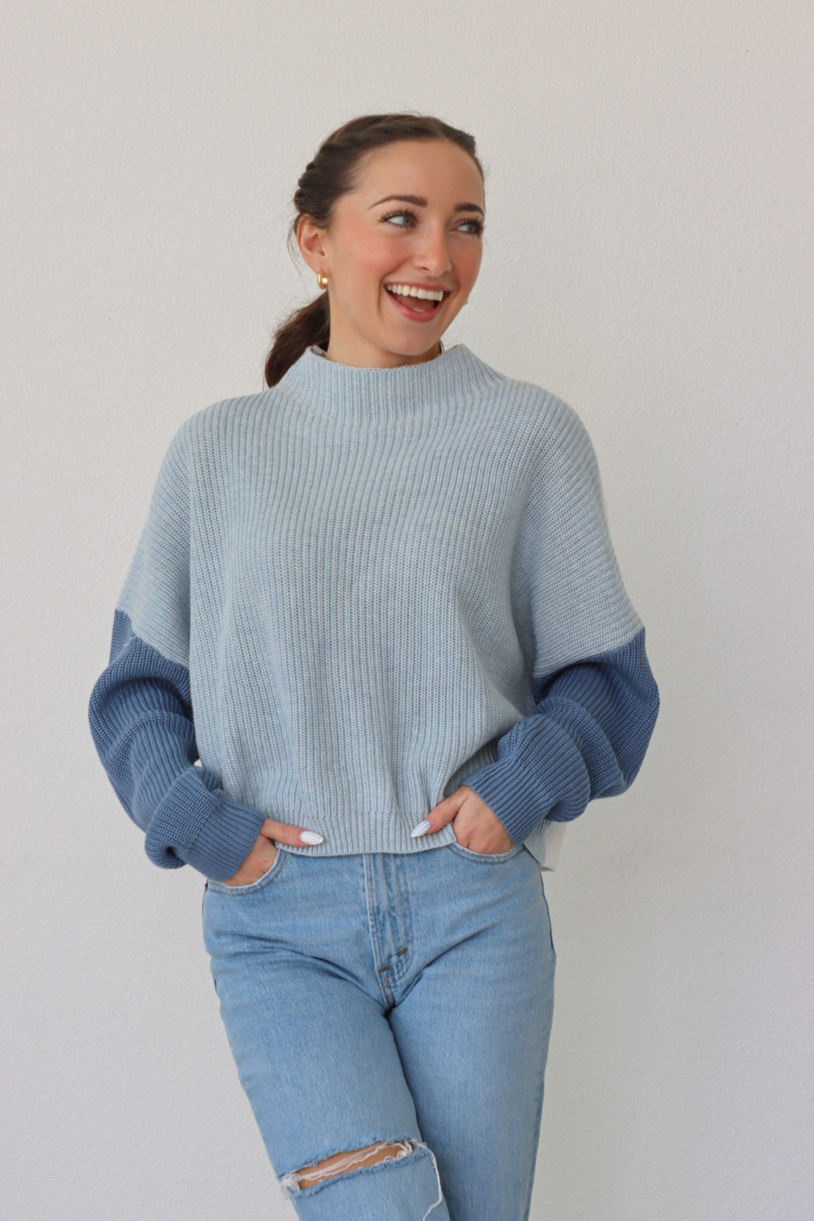 girl wearing blue & white colorblocked sweater