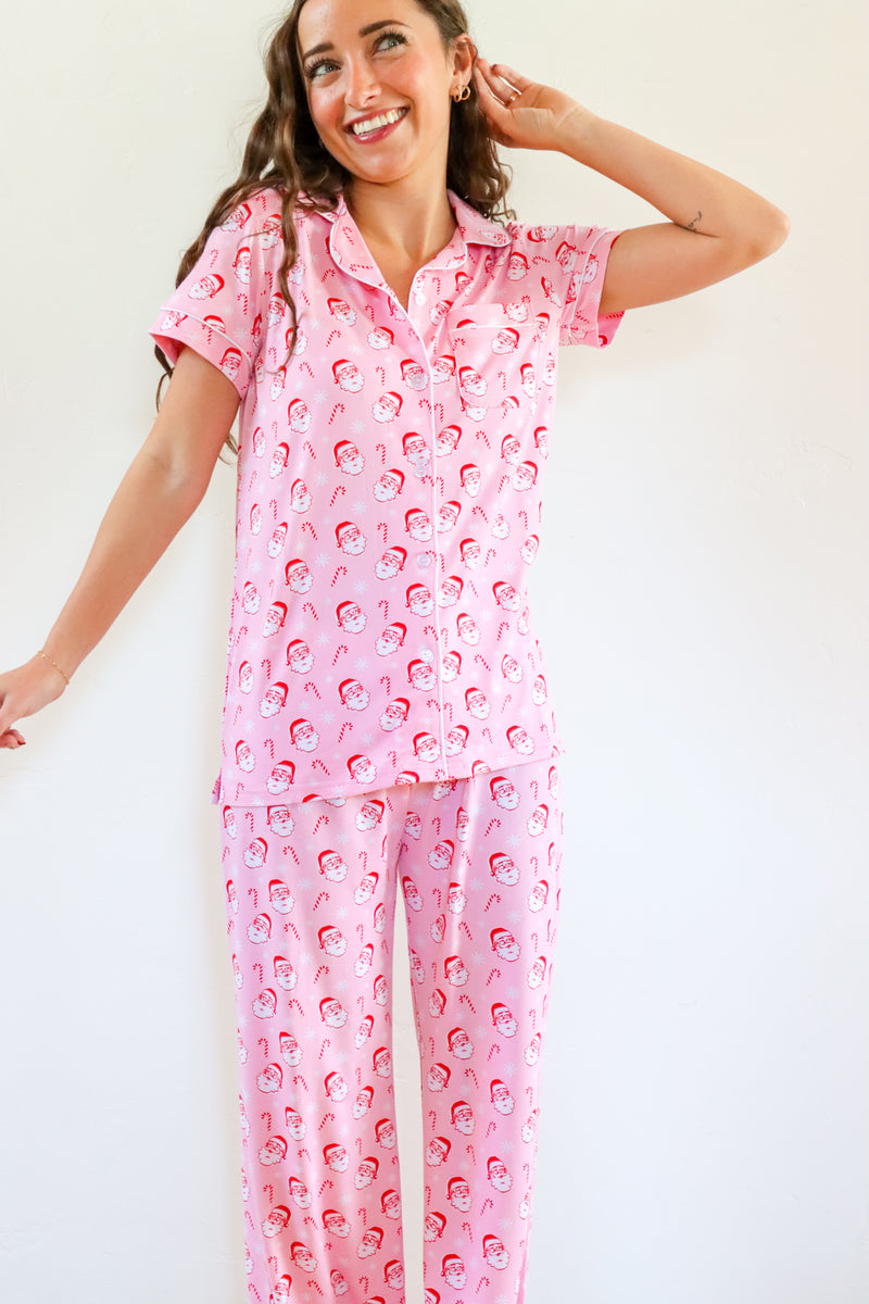 Woman wearing pink pajamas with a pattern on a white background