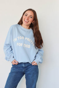 girl wearing light blue "i'm too pretty for this" crewneck