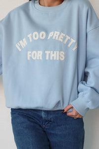 girl wearing light blue "i'm too pretty for this" crewneck