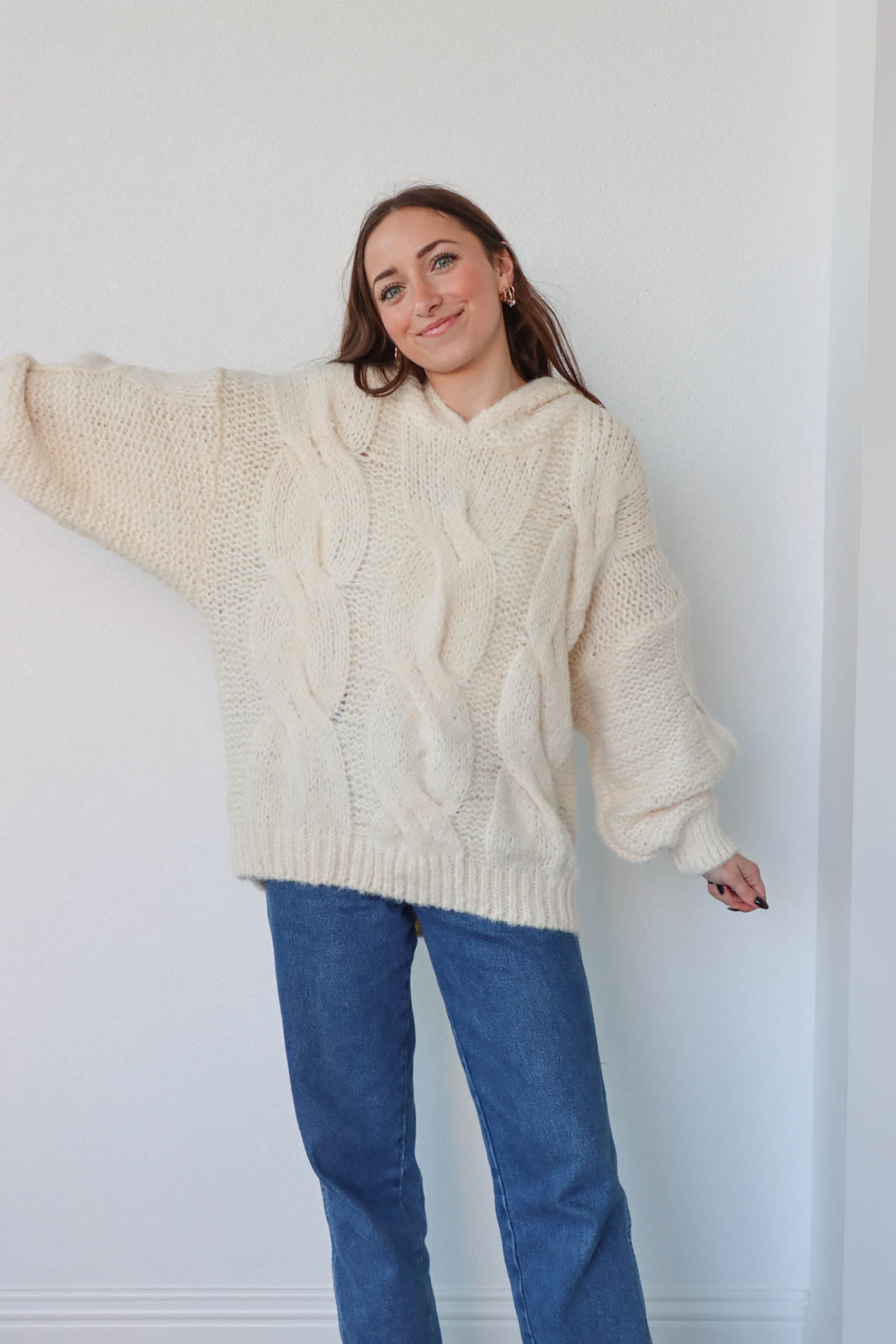 girl wearing cream cable knit hoodie