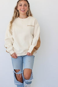 girl wearing color block sweatshirt with "Don't Know" on the front and "Don't Care"