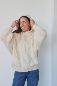 girl wearing cream cable knit hoodie