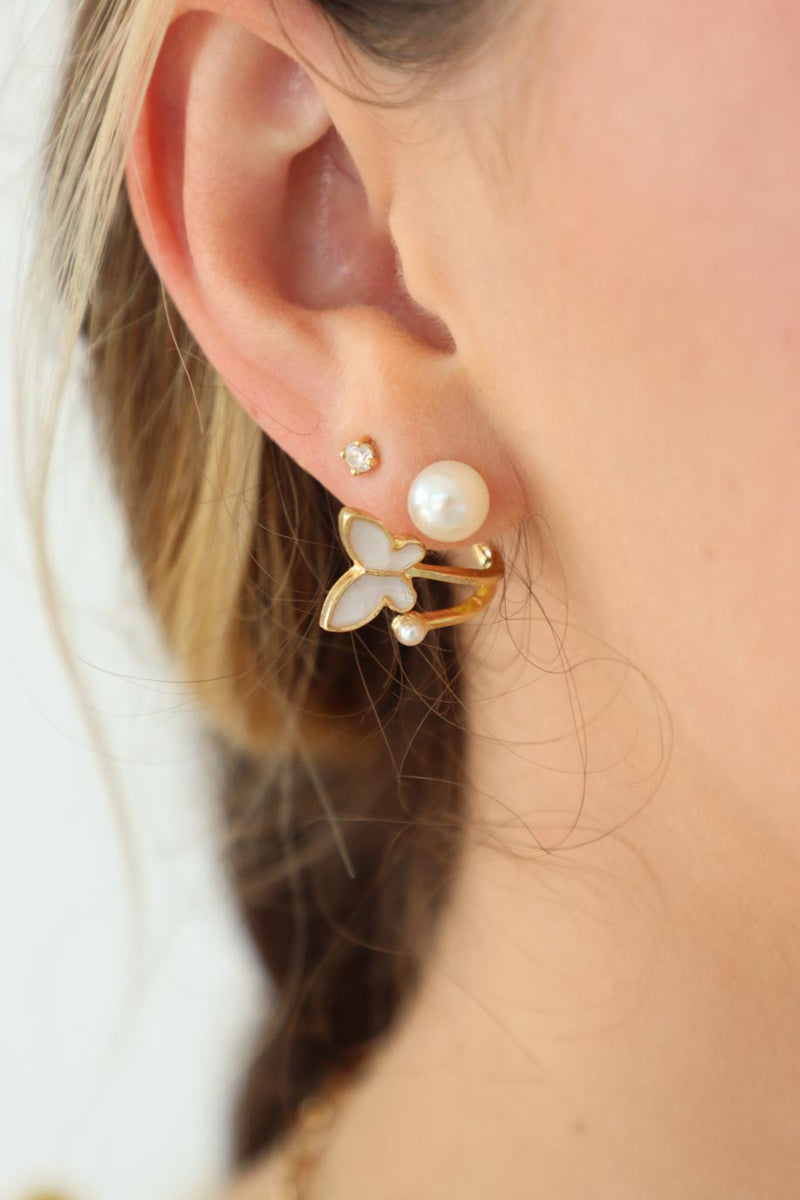 girl wearing pearl butterfly earrings