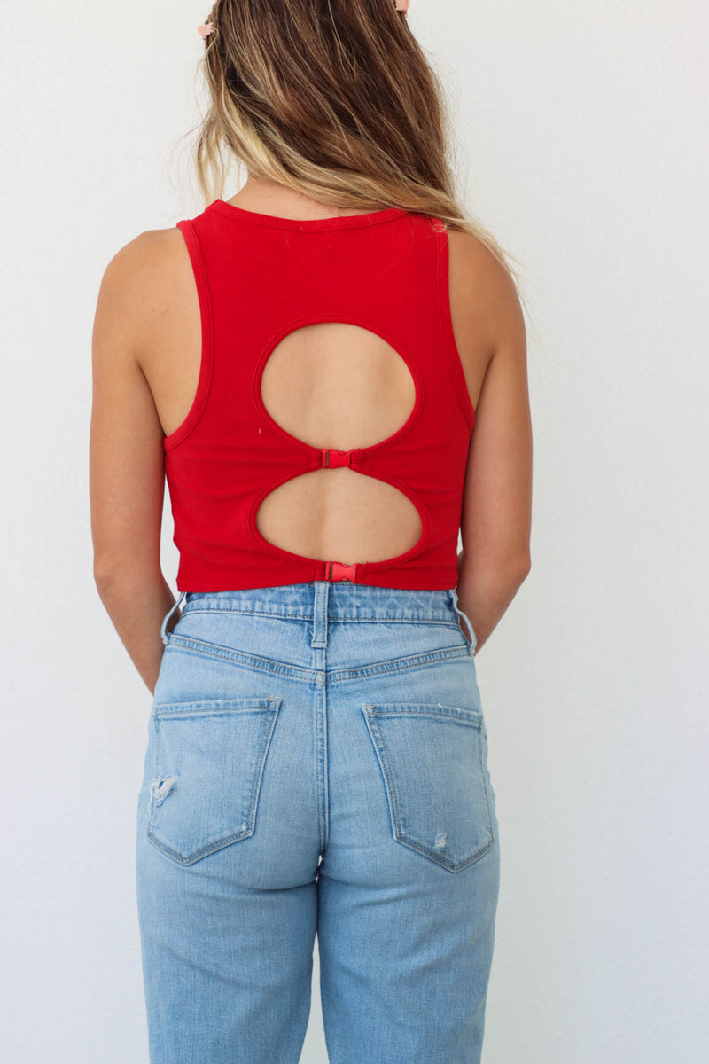 girl wearing red tank top with buckle detailing on the back