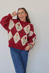 girl wearing red floral crochet sweater