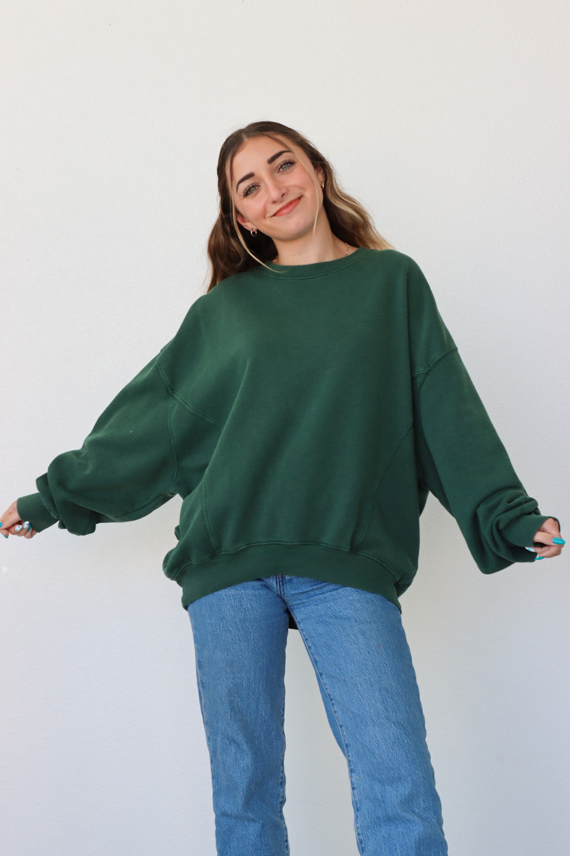 girl wearing dark green crewneck sweatshirt