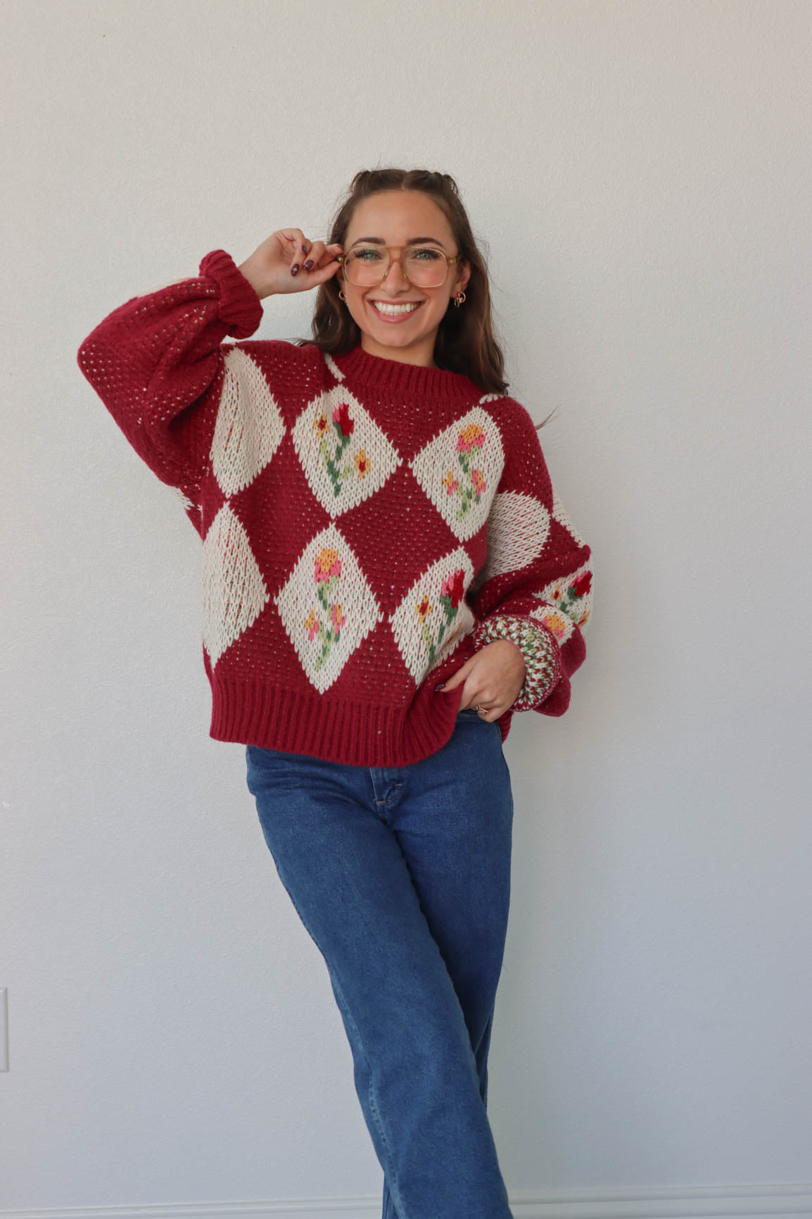 girl wearing red floral crochet sweater