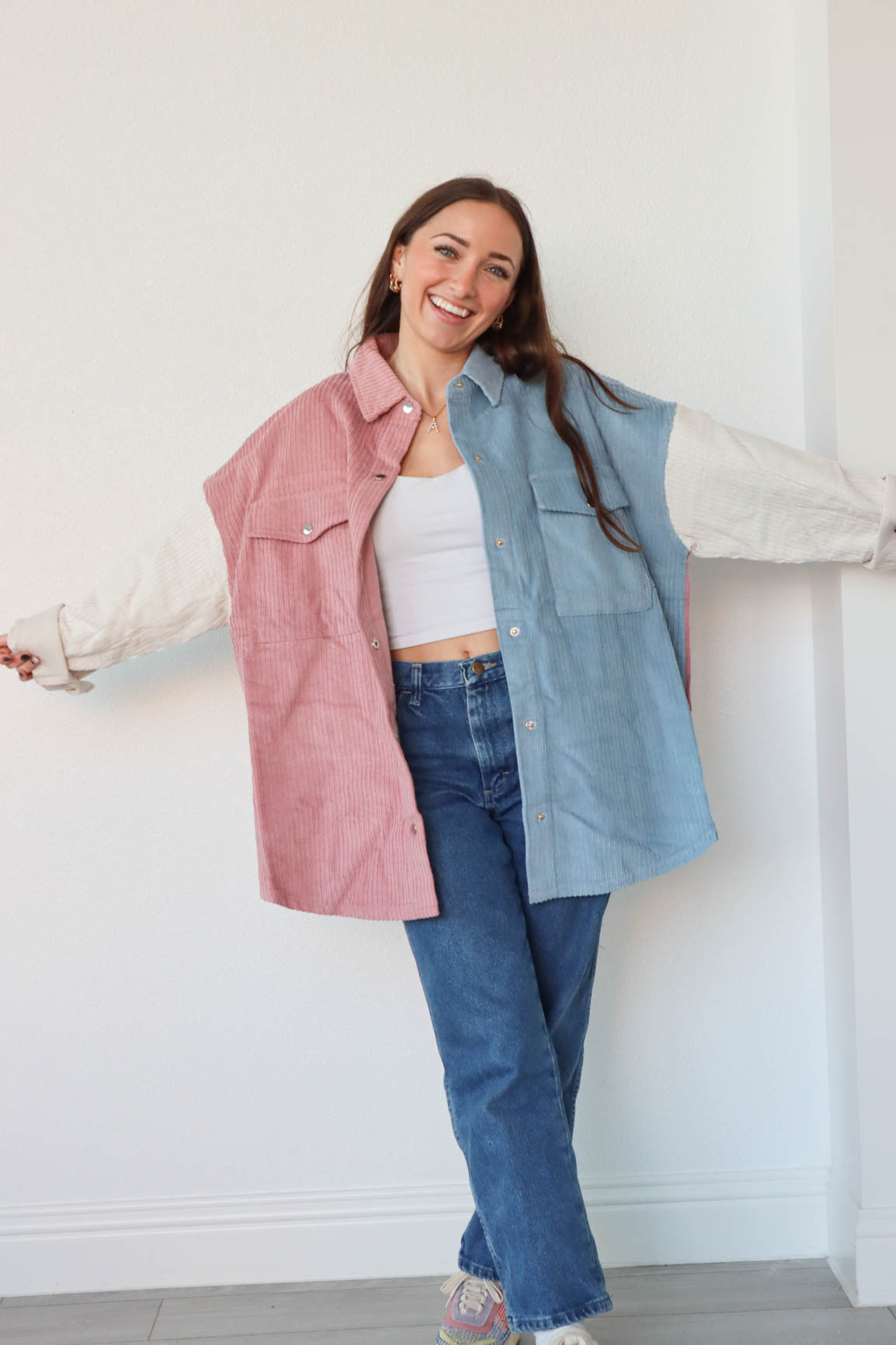 girl wearing pink, white, and blue pastel corduroy jacket