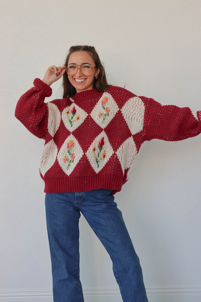 girl wearing red floral crochet sweater