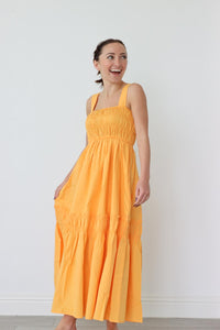 girl wearing orange tank top maxi dress