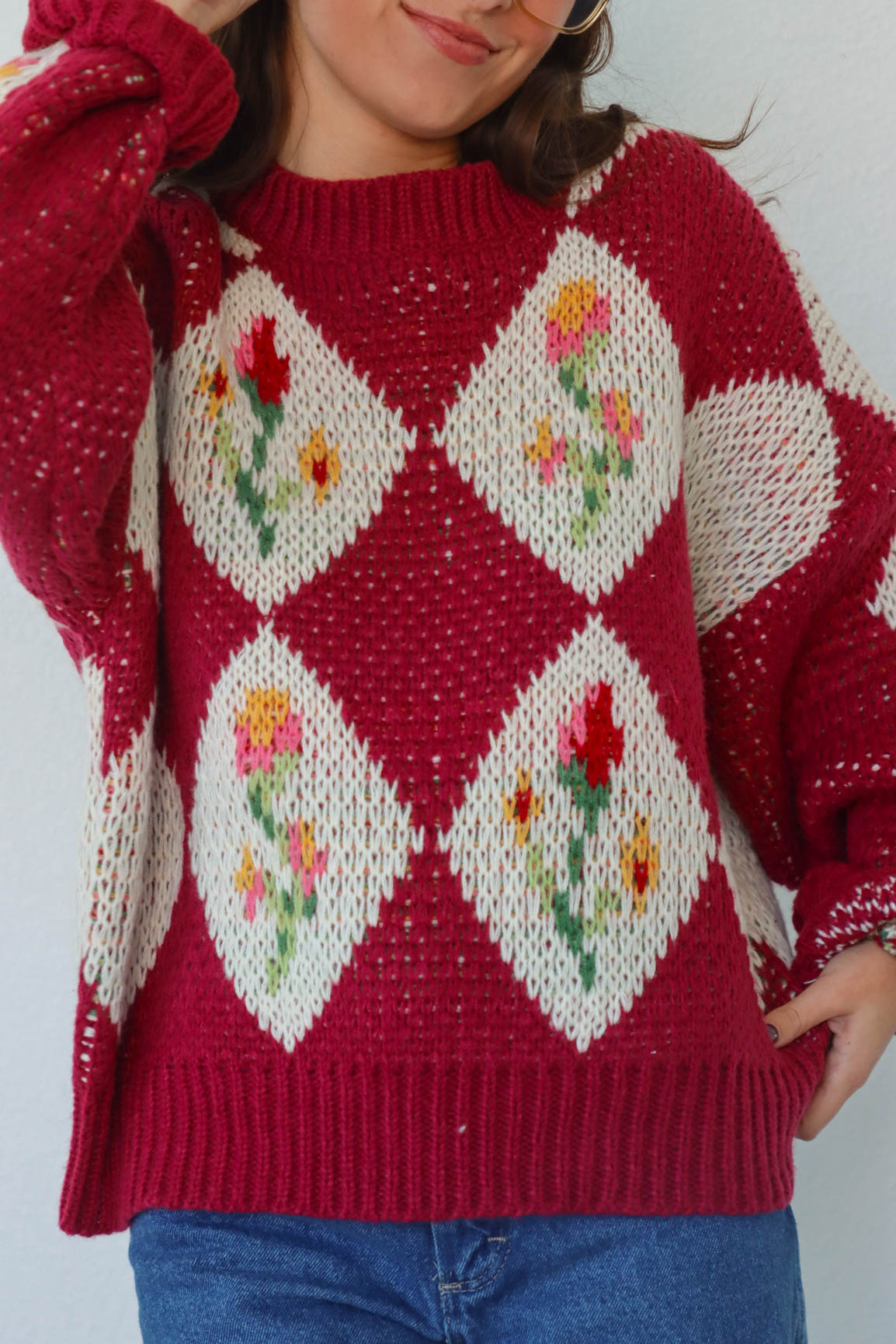 girl wearing red floral crochet sweater