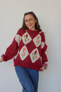 girl wearing red floral crochet sweater