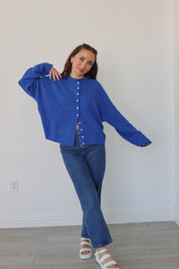 girl wearing royal blue cardigan