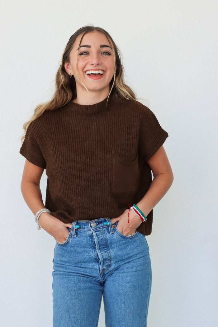 girl wearing dark brown knit short sleeve top
