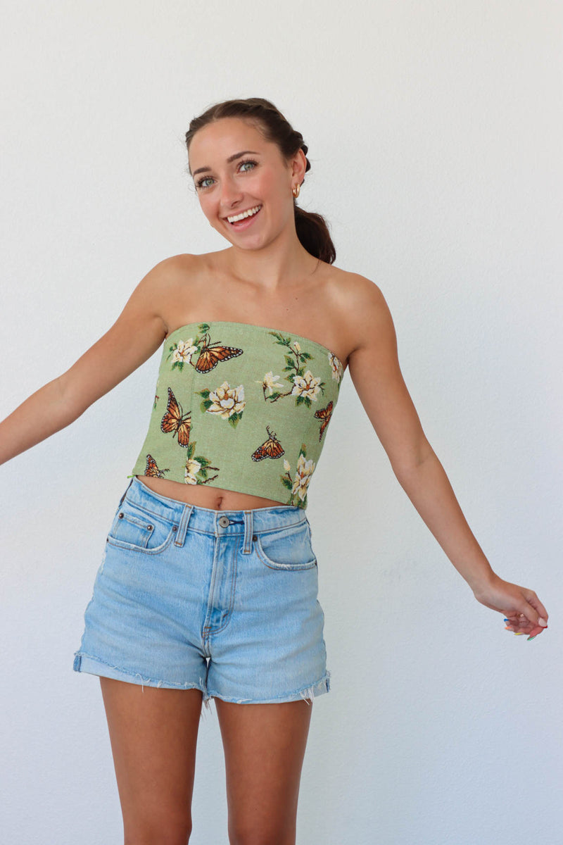 girl wearing green butterfly floral corset top