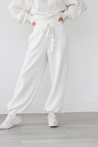 girl wearing white drawstring sweatpants