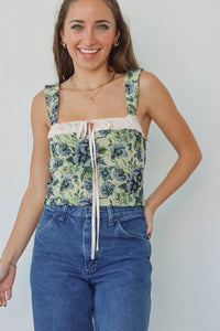 girl wearing green & blue floral corset top