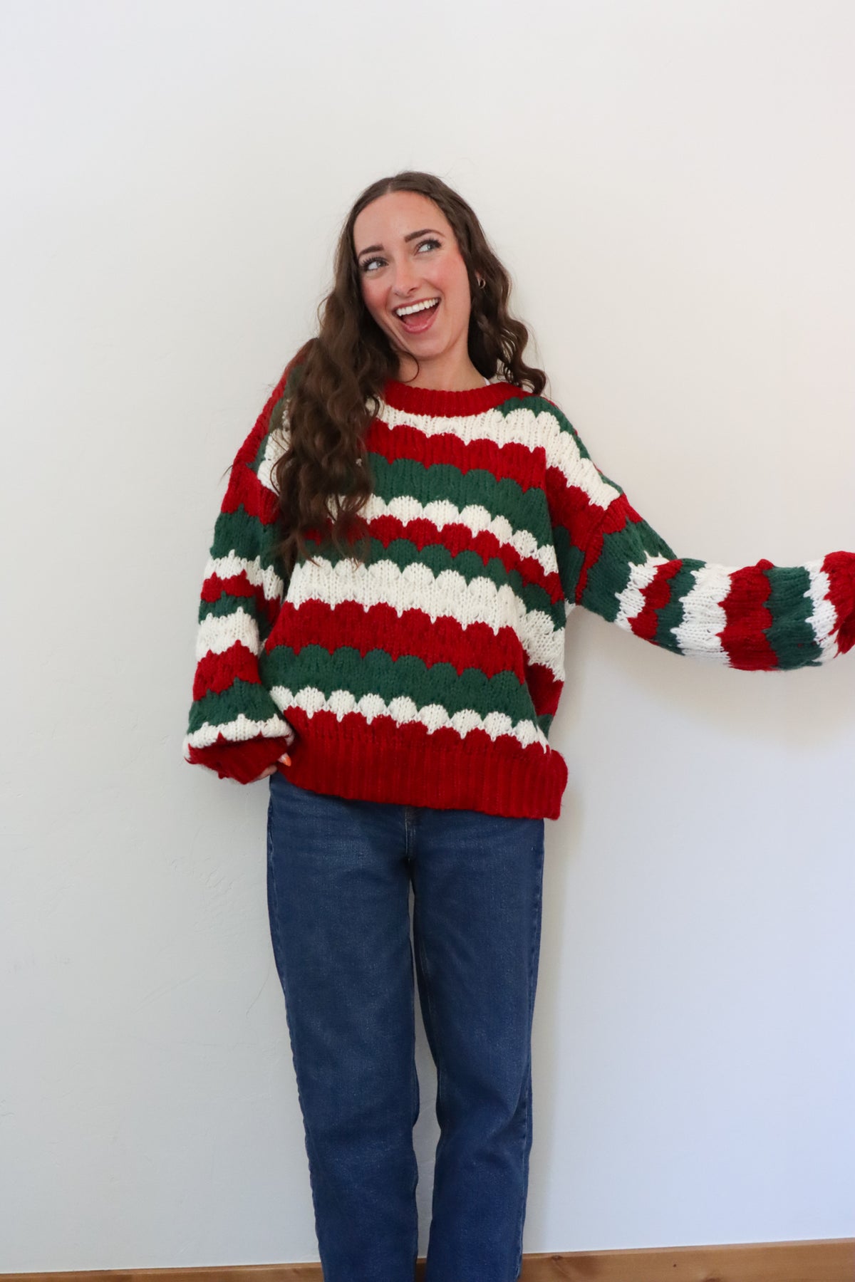 girl wearing red, green, and white striped sweater