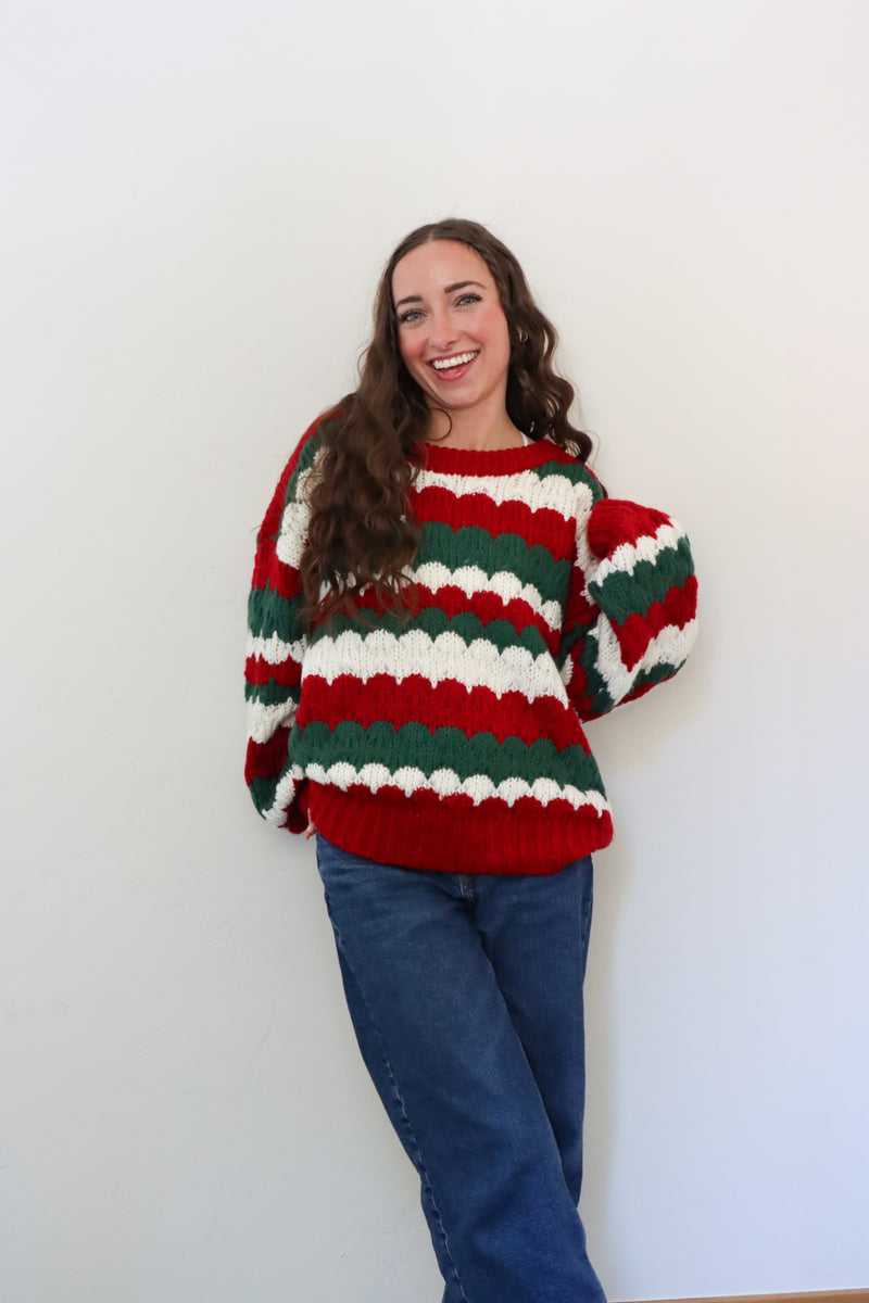girl wearing red, green, and white striped sweater