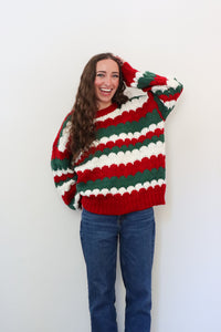 girl wearing red, green, and white striped sweater