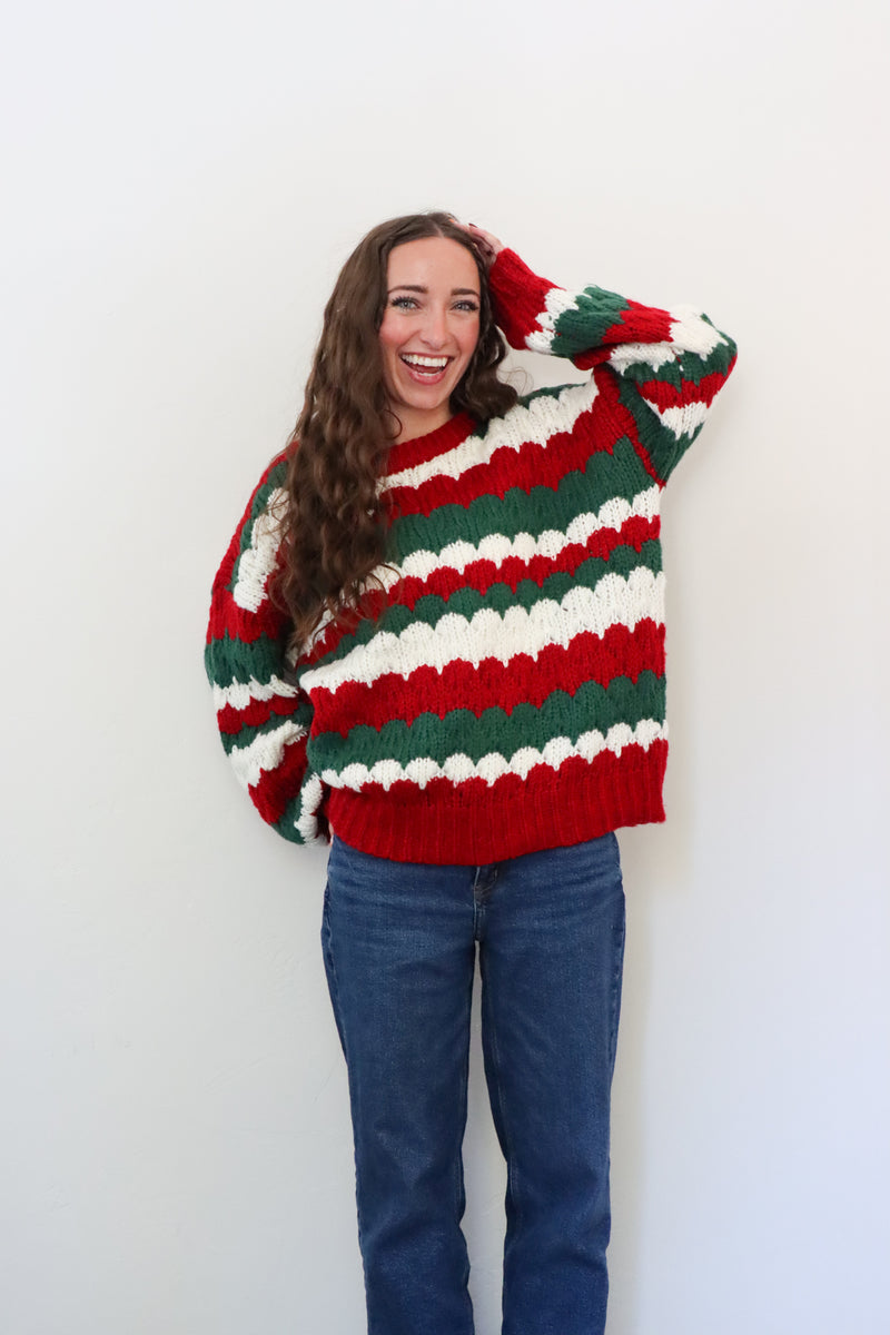 girl wearing red, green, and white striped sweater