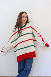 Woman wearing a colorful striped sweater against a white background