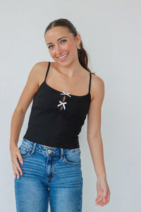 girl wearing black tank top with white bow detailing