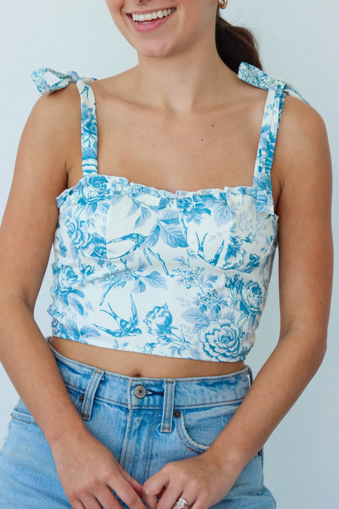 girl wearing cream and blue floral tank top