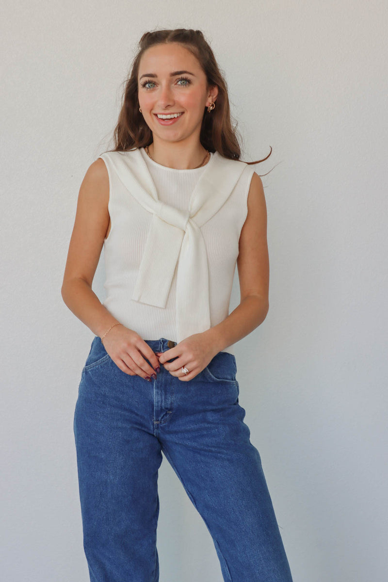 girl wearing white knit tank top