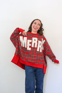 Person wearing a red plaid sweater with 'Merry' text against a white background