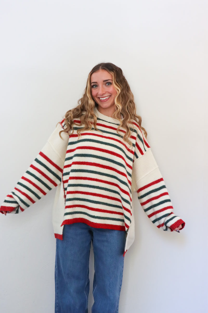 Person wearing a striped sweater with a white background