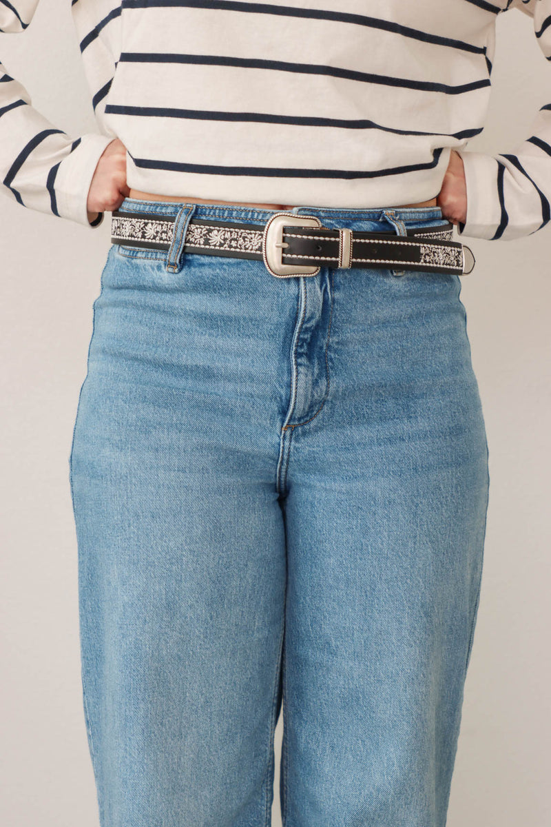 girl wearing black western style belt