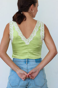 girl wearing lime green lace, cropped tank top