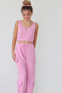 girl wearing pink matching set; sweatpants and sports bra