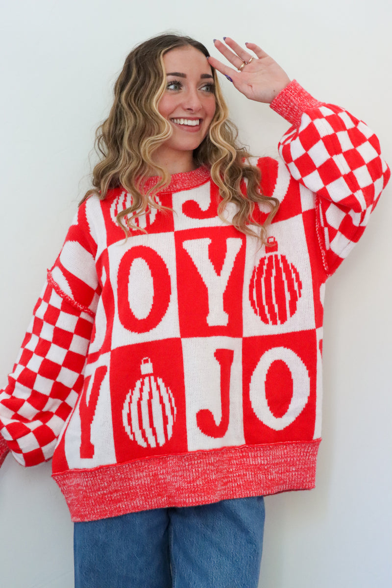 girl wearing red and white check joy sweater