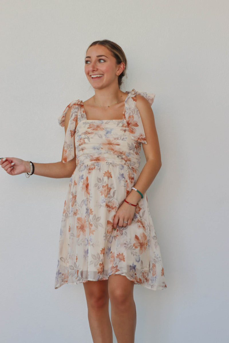 girl wearing cream floral dress