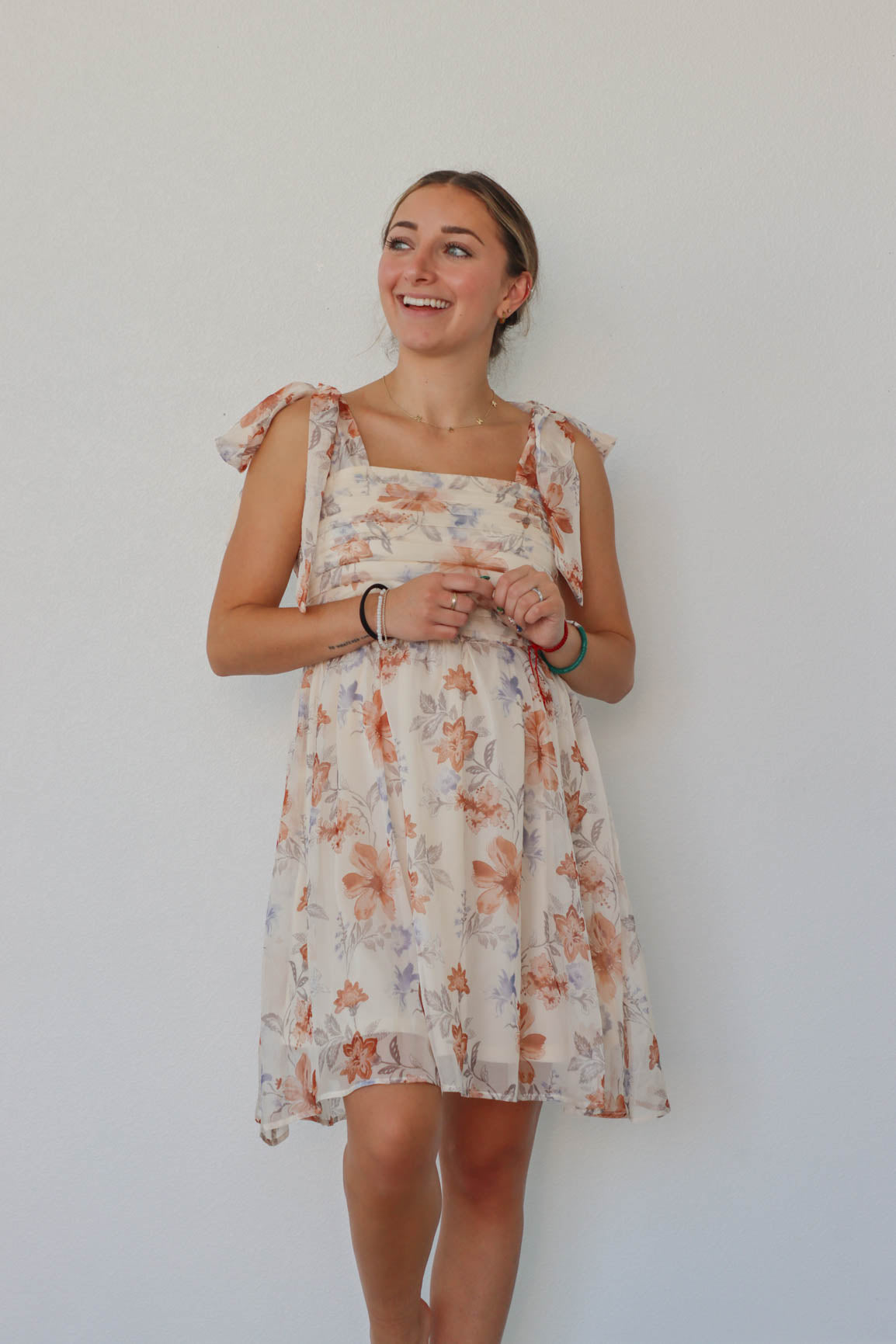 girl wearing cream floral dress