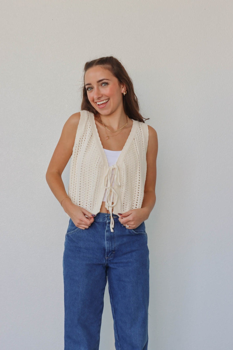 girl wearing cream crochet tank top