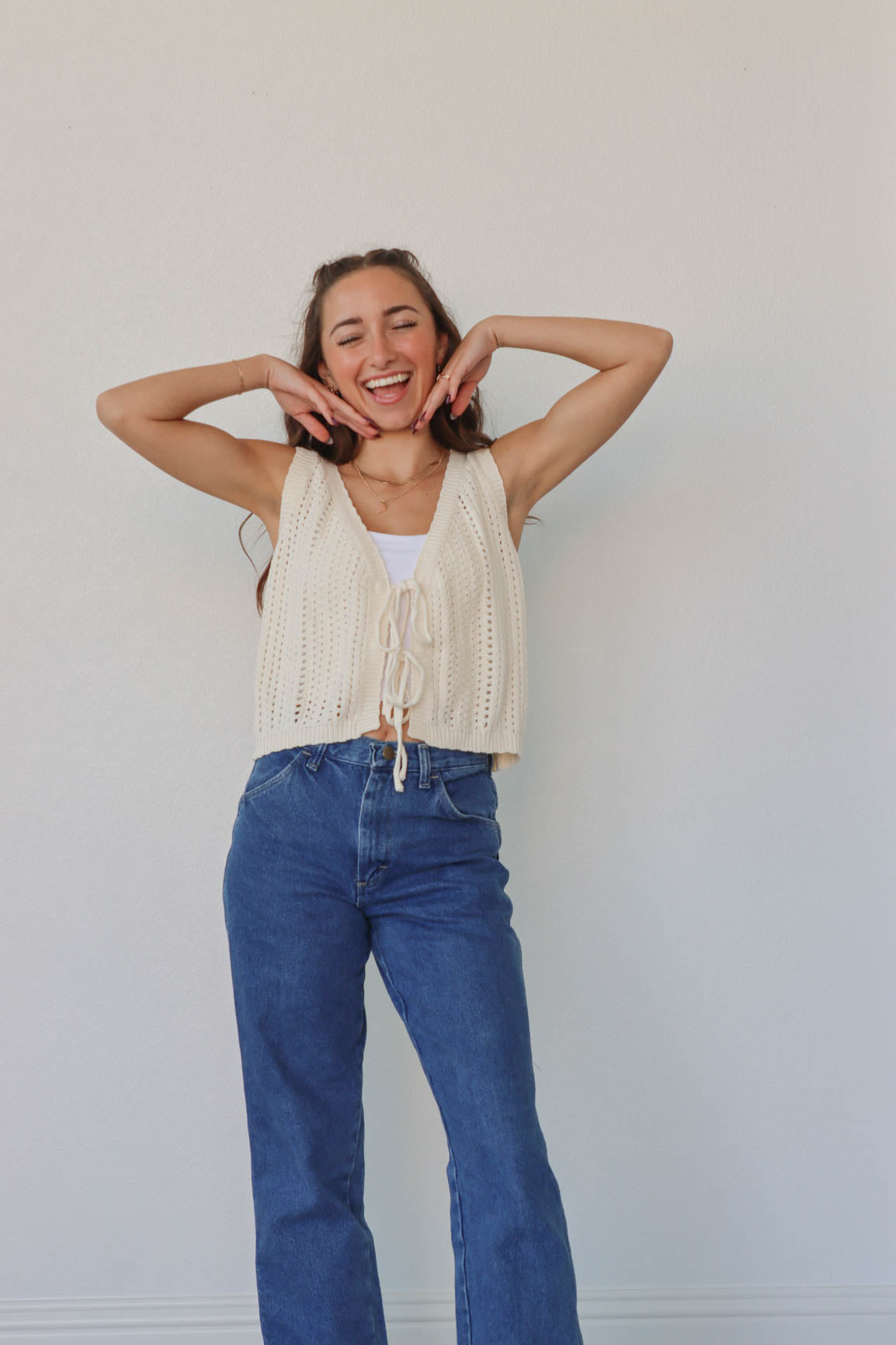 girl wearing cream crochet tank top