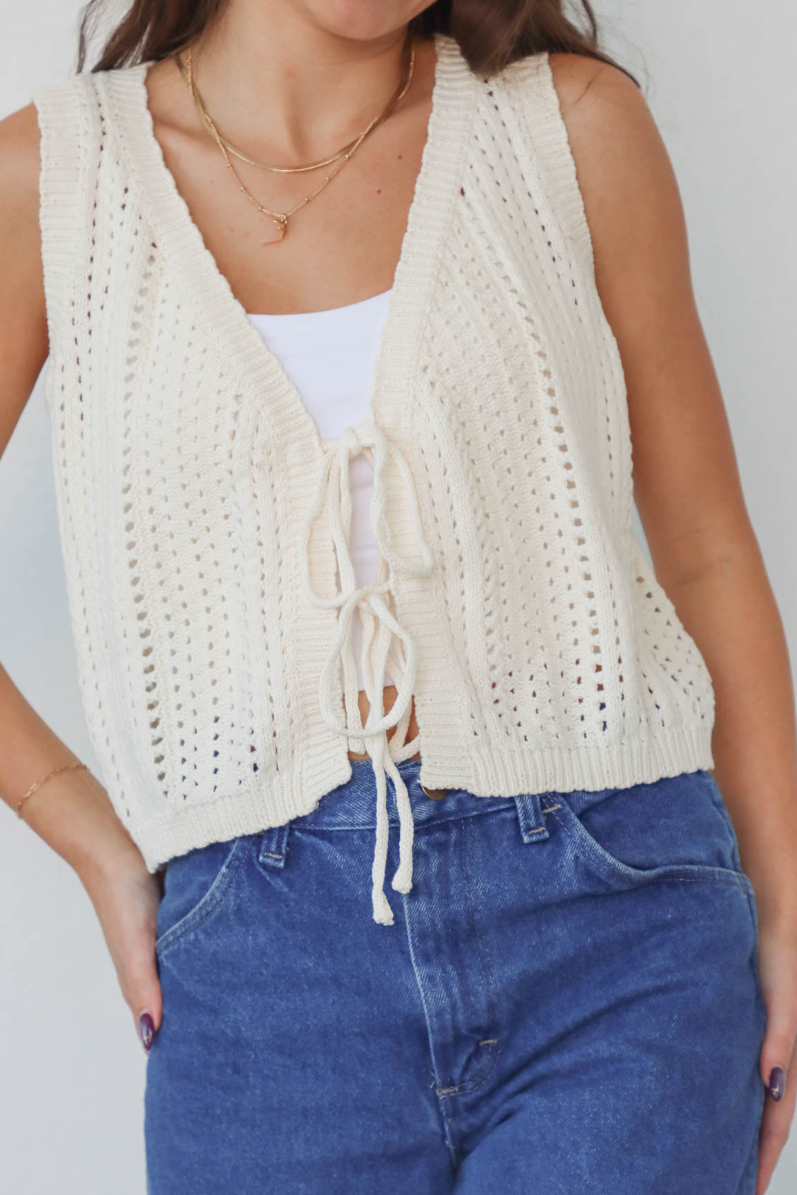 girl wearing cream crochet tank top