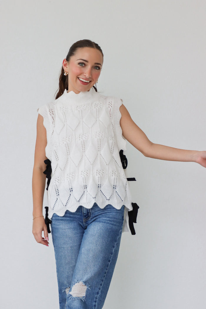 girl wearing white knit top