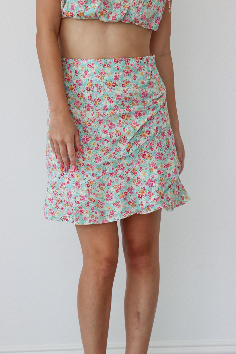 girl wearing floral matching set; cropped tank and skirt