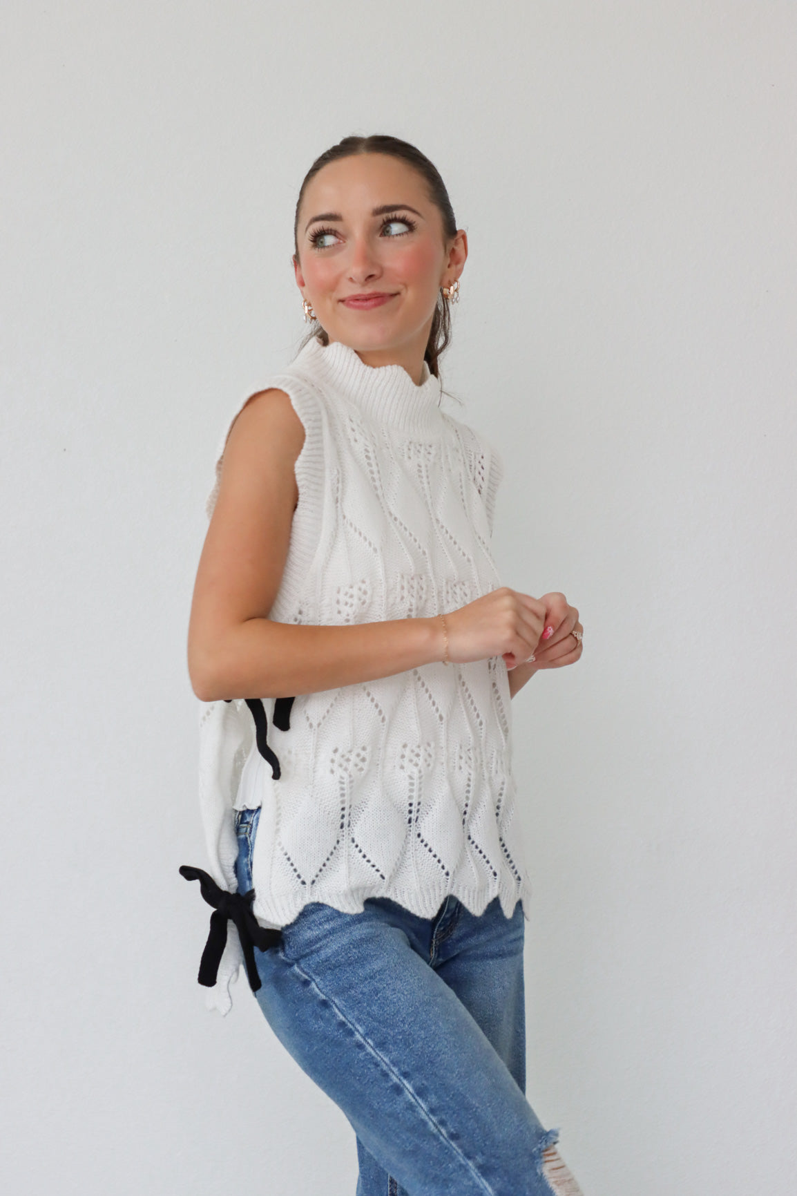 girl wearing white knit top