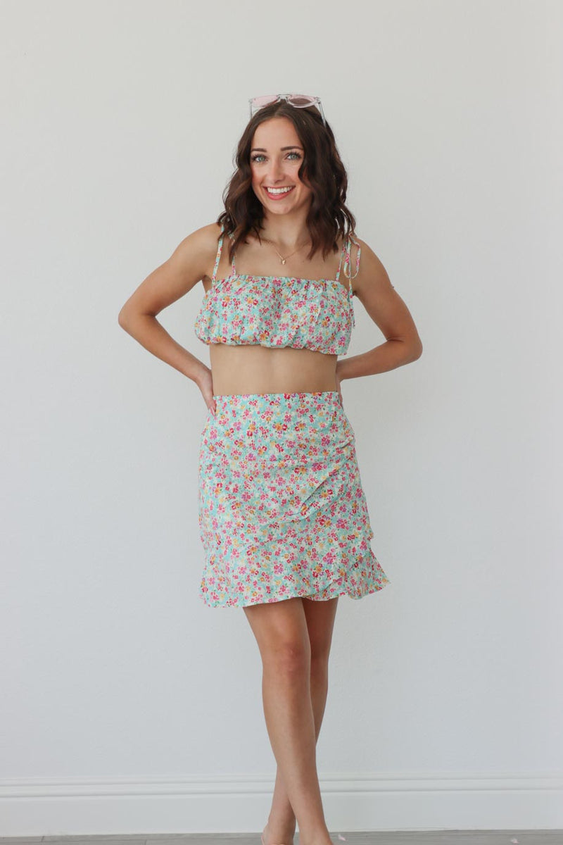 girl wearing floral matching set; cropped tank and skirt