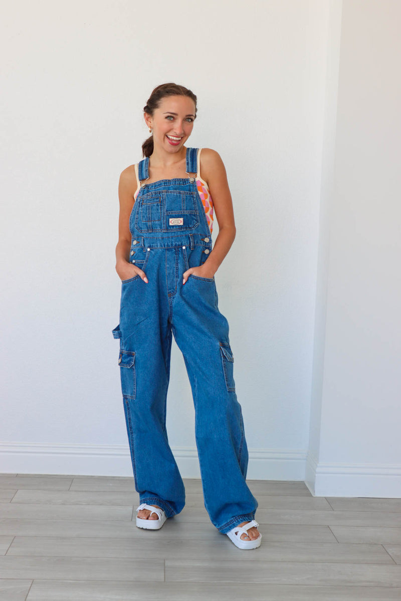 girl wearing blue denim long overalls