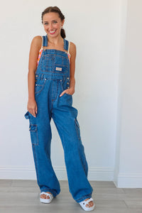 girl wearing blue denim long overalls