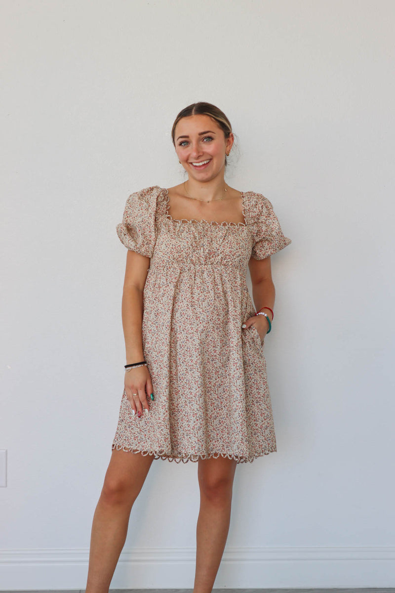 girl wearing tan floral short dress