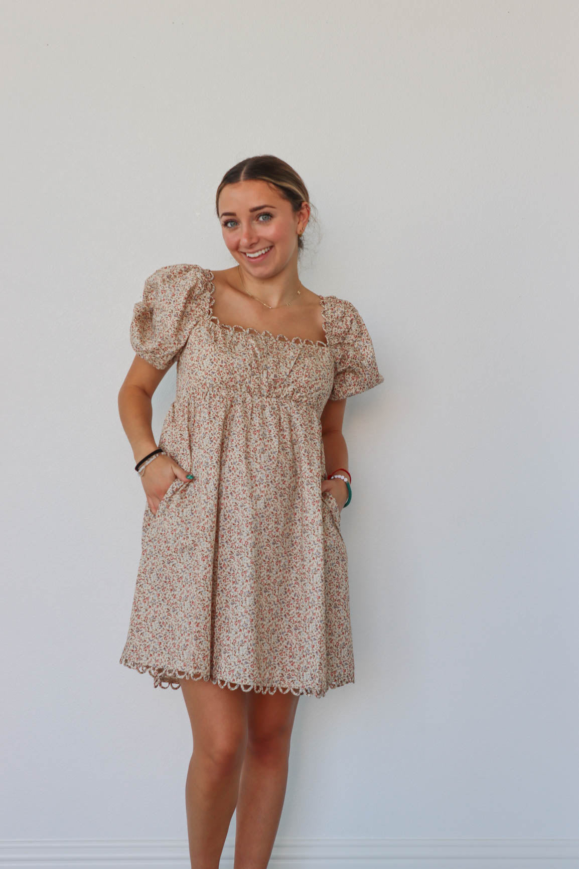 girl wearing tan floral short dress